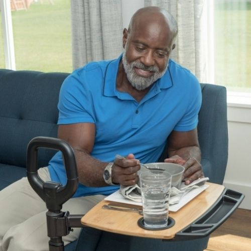 Assist-A-Tray Man Image of man using the Assist-A-Tray while sitting on the couch.