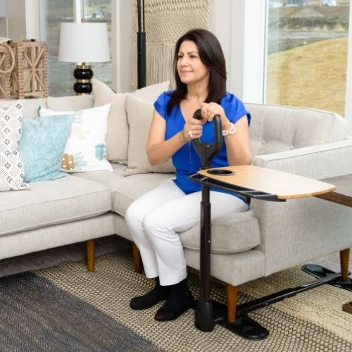 Image of woman holding on to Assist-A-Tray while sitting on the couch.