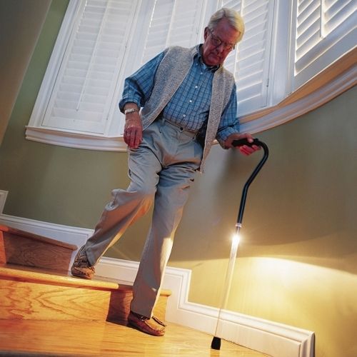 Image of the Pathlighter Adjustable Lighted Cane	being used on steps.