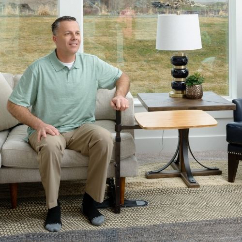 Image of man using Omni Tray to stand up with support.