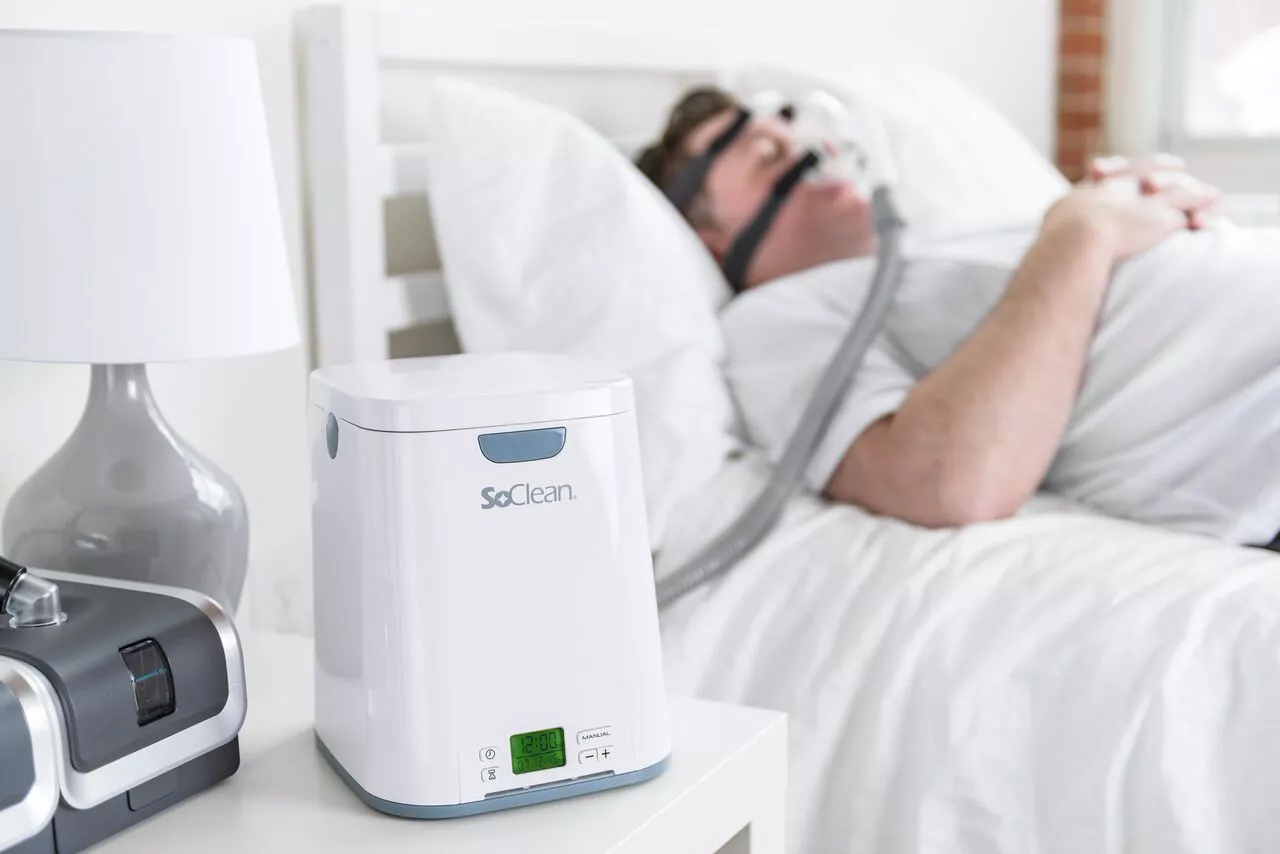 Image of man sleeping with SoClean near.