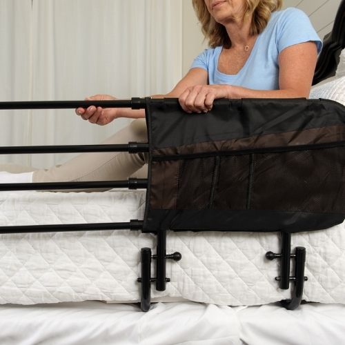Woman extending the Stander EZ Adjust Bed Rail.