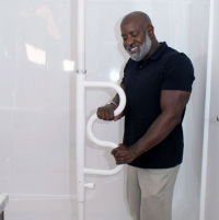 Image of man using the Security Pole & Curve Bar in the shower. thumbnail