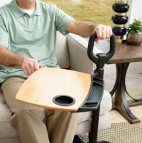 Man swiveling tray away from himself while sitting on the couch. thumbnail
