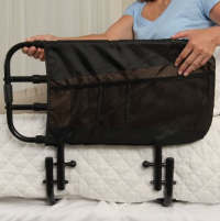 Woman sitting in bed and holding the Stander EZ Adjust Bed Rail. thumbnail