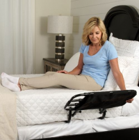 Woman laying in bed using the Stander EZ Adjust Bed Rail. thumbnail